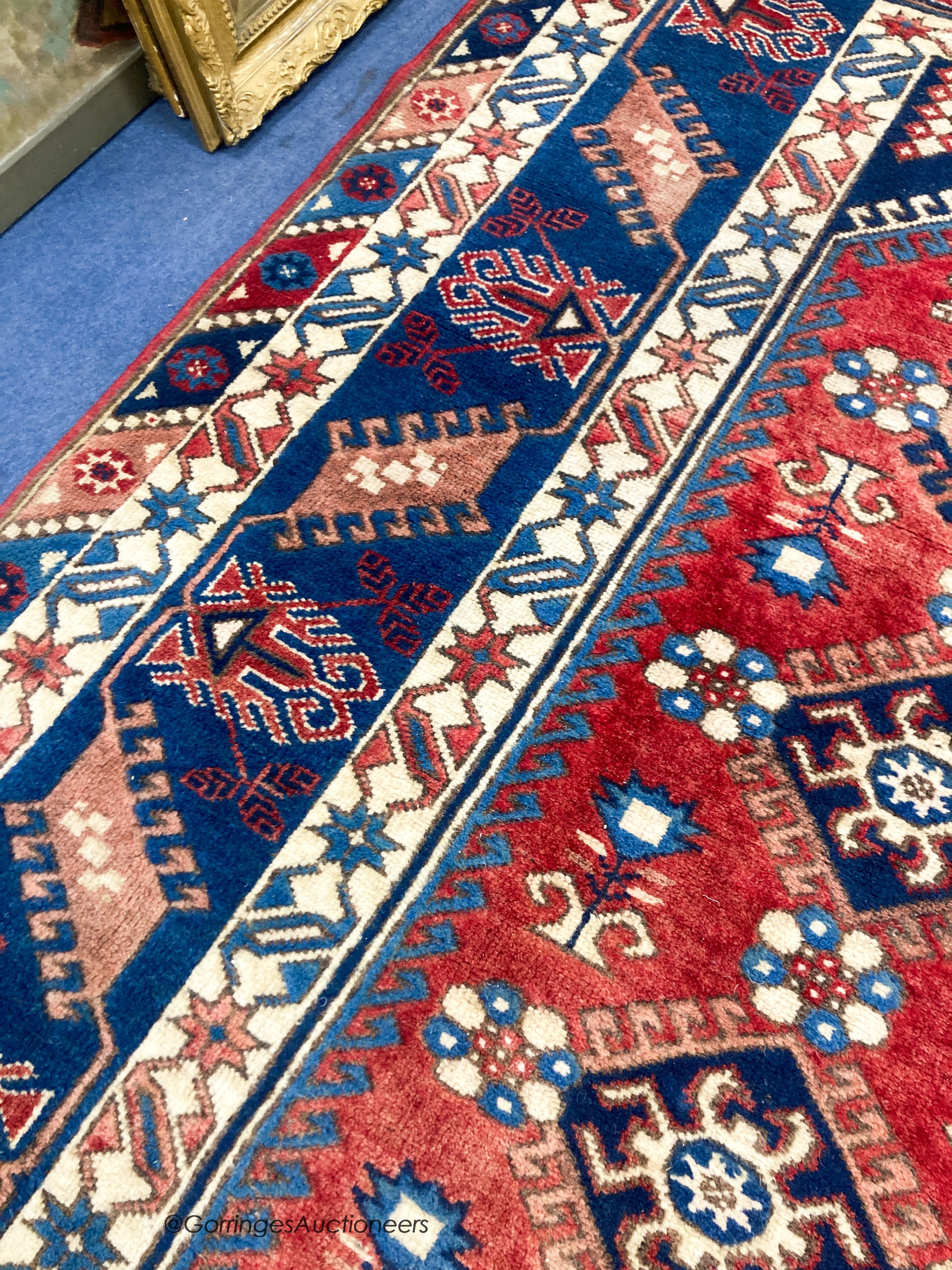 A Caucasian design blue ground rug, 240 x 152cm